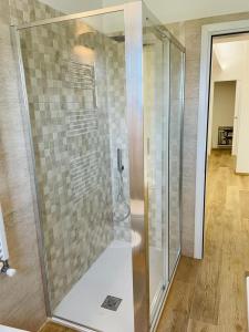 a shower with a glass door in a bathroom at Mauris Home in Tortolì