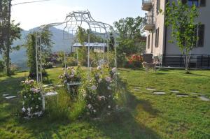 a garden with flowers and a deer in a yard at Rose e Cioccolato B&B in Borgo Val di Taro