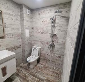 y baño con aseo y ducha. en Fully furnished Apartment en Varna