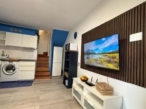a kitchen with a tv on a wall at Canarian Green Oasis by luca properties gran canaria in Maspalomas