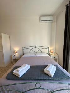1 dormitorio con 1 cama con 2 toallas en Eufonia Gemelli Apartment en Roma