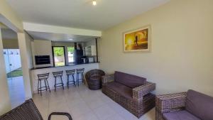 a living room with a couch and a bar at Residencial Ferrugem Beira Mar in Garopaba