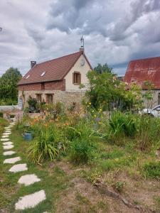 a brick house with a garden in front of it at Chambre table d'hôtes Anne-Marie et Jean-Christophe in Ferrières-en-Bray