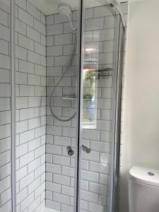 a shower with a glass door in a bathroom at The Old Bakery in South Cerney
