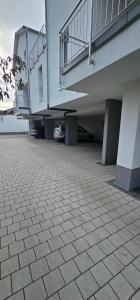 an empty parking lot with a building with a staircase at MaMaM´s Apartment in Kappel-Grafenhausen