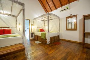 Giường trong phòng chung tại Jungle Shades villa - Habarana