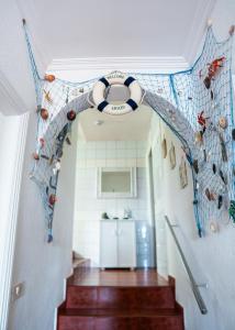 a hallway with a spiral staircase with a lifebuoy on the wall at Punta Mar in Güimar