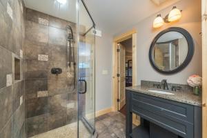 a bathroom with a shower and a sink at Blue Ridge Bliss Gorgeous home with hot tub & stunning views in Weaverville +31 photos