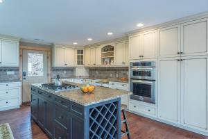 a kitchen with a island with a bowl of fruit on it at Blue Ridge Bliss Gorgeous home with hot tub & stunning views in Weaverville