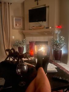 a person with their feet on a table with a fireplace at Scottsdale Retreat in Scottsdale