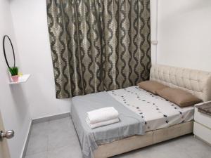 a small bed in a room with a curtain at Sierra Hill Homestay 2 in Kampong Changi