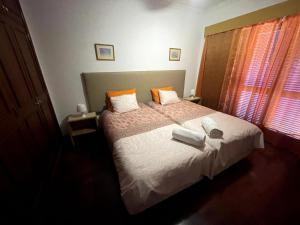 a bedroom with a bed with two towels on it at Your Home In Madeira III in Funchal