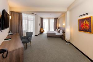 a hotel room with a bed and a couch at DiliJazz Hotel & Restaurant in Dilijan