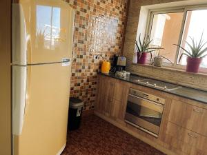 a kitchen with a yellow refrigerator and a window at Hammam Antistress in Sousse