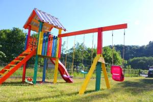 a colorful playground with a slide and a slide at CONACUL DE SUB MUNTE in Novaci-Străini