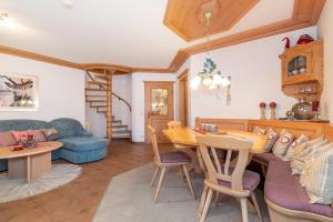 a kitchen and living room with a table and chairs at Ferienwohnung Elisabeth in Reit im Winkl