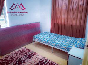 a small room with a bed and a red curtain at D landai homestay in Pekan