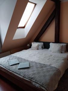 a bedroom with a bed with two books on it at Penzion Albatros in Český Krumlov