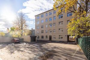 a parking lot in front of a large building at Apartment in a renovated property, 30 m2 in Riga
