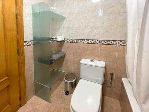a bathroom with a toilet and a glass shower at Casa playa Melosas- Torre del mar- HOME RENT MALAGA in Torre del Mar +20 photos