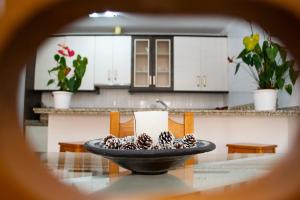 a kitchen with a bowl of pine cones on a table at Casa playa Melosas- Torre del mar- HOME RENT MALAGA in Torre del Mar