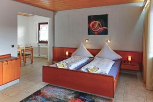 a bedroom with a bed with white pillows at Hotel Garni Sebastian in Kirrweiler