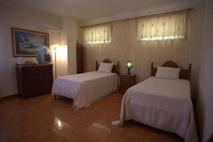a hotel room with two beds and a television at Casa Das Aguas Ferreas in Estação do Mogadouro