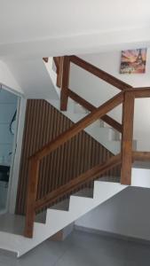 a staircase in a house with wooden railings at Chalé Lua Azul in Jaraguá do Sul