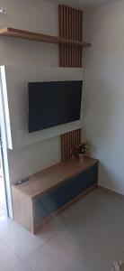 a flat screen tv hanging on a wall at Chalé Lua Azul in Jaraguá do Sul