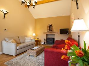 a living room with two couches and a fire place at 1 Bed in Howden G0181 in Saltmarshe