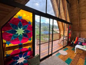 a room with a large window with a colorful mosaic wall at Casa Índigo Tabio in Tabio