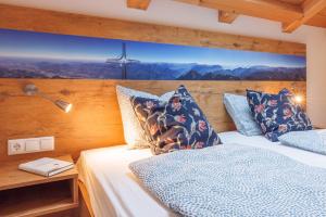 a bedroom with a bed with blue pillows at Taubennest 