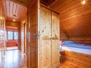 a wooden room with a bed in a log cabin at 3 Bed in Clovelly 00367 in Clovelly