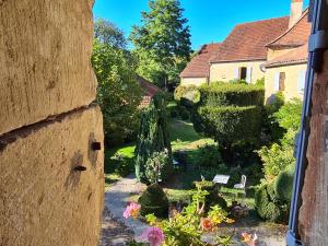 a view of a garden from a building at Ferme de Tayac - Charme avec Pool in Les Eyzies-de-Tayac