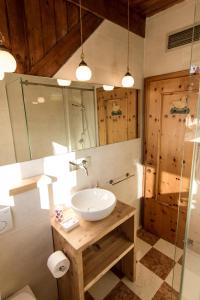 a bathroom with a sink and a glass shower at App Carolina in Creazzo