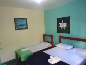 En eller flere senge i et værelse på Pousada Cavalo Marinho