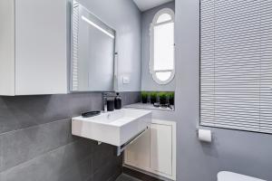 a bathroom with a white sink and a mirror at BDC - Fancy 2-Bdr Apt @Vatican in Rome