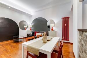 a dining room with a white table and chairs at BDC - Fancy 2-Bdr Apt @Vatican in Rome