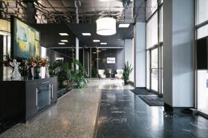 an empty office with plants in the middle of a hallway at Atlanta Downtown City View Free Onsite Parking Entire Condo LM1607 in Atlanta