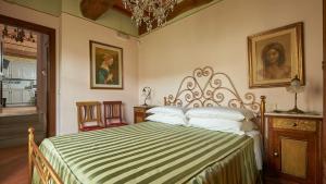 a bedroom with a bed with a black and white comforter at Antico Borgo Frosini in Arezzo