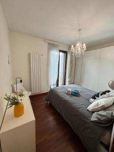 a bedroom with a large bed and a chandelier at Michelangelo Apartment Pescara in Pescara