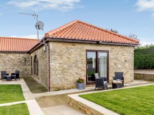 a stone cottage with a patio and lawn at 2 bed in Hamsterley 80004 in High Etherley