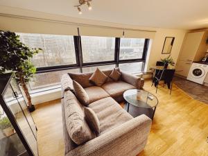 a living room with a couch and a table at 2 Bed Apartment Sleeps 6 Modern Secure Parking + Lift in Newcastle upon Tyne