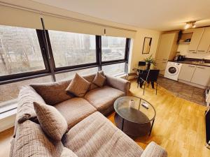 a living room with a couch and a table at 2 Bed Apartment Sleeps 6 Modern Secure Parking + Lift in Newcastle upon Tyne