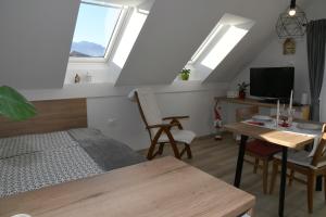 a bedroom with a bed and a desk with a table at Apartments Ajda in Bohinj