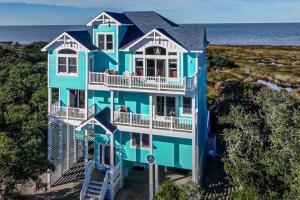 an aerial view of a blue house at Blue Waters #18-22 in Avon