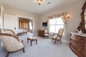 a room with a bedroom with a bed and a dresser at Clifton House - Panorama - Queen Suite, Sleeps 4, River Views in Natchez