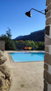 a swimming pool with a light on a building at Casa Fraga do Suadouro in Campo do Gerês