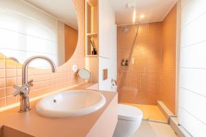 a bathroom with a sink and a toilet at La Maison De Blanche in Bordeaux