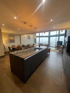 a living room with a large island in the middle at Pendle View by Valley View Lodges in Longridge